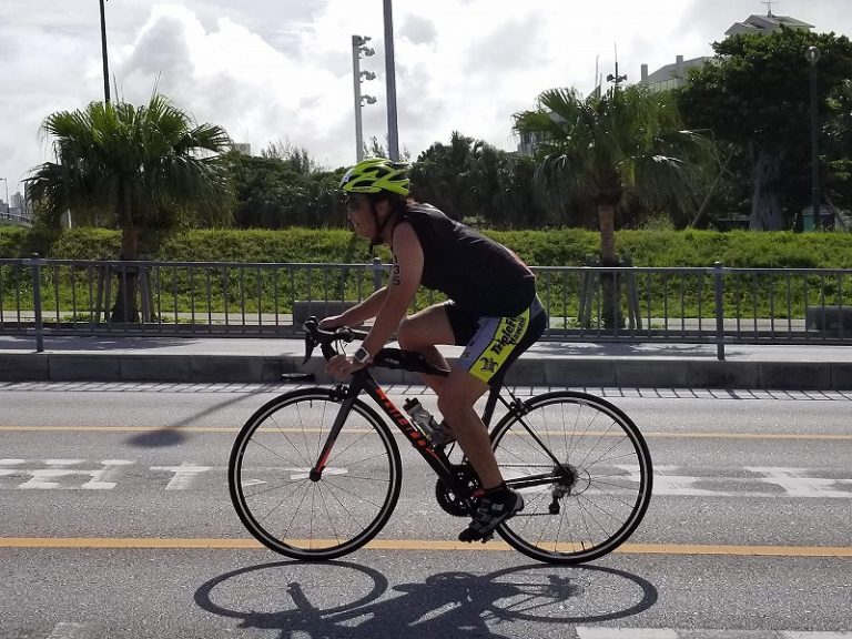 Male triathlete riding bike in Naha, Okinawa