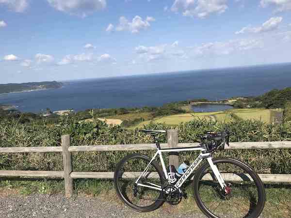 bike on side of road with coast in background