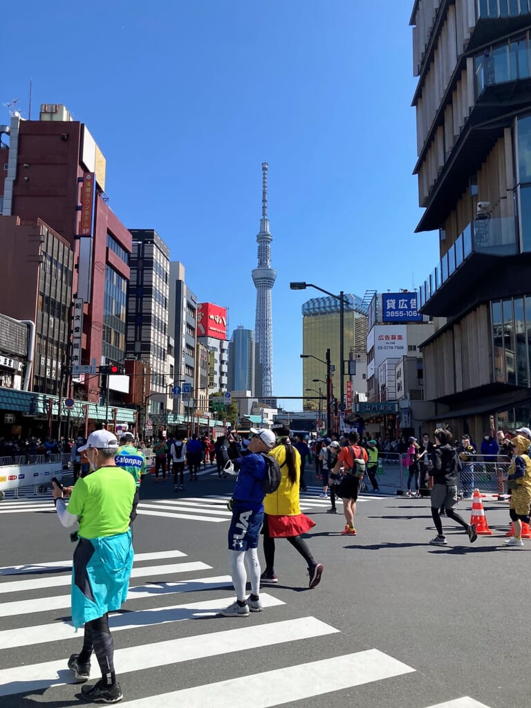 Runners on the Tokyo Marathon course by Tokyo Skytree